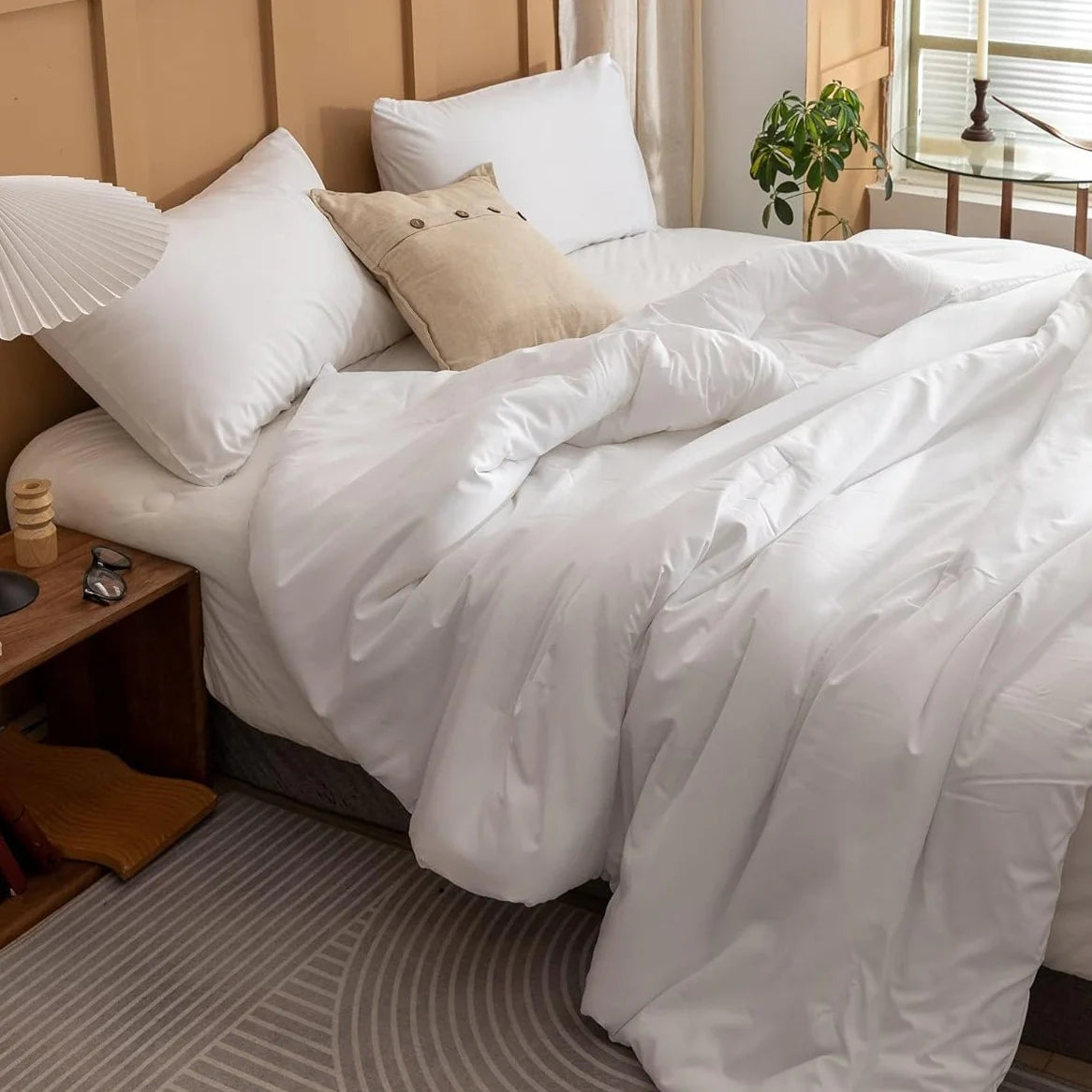 Minimalist white cotton bed sheets on a neatly made bed, emphasizing soft, breathable fabric, perfect for sensitive skin