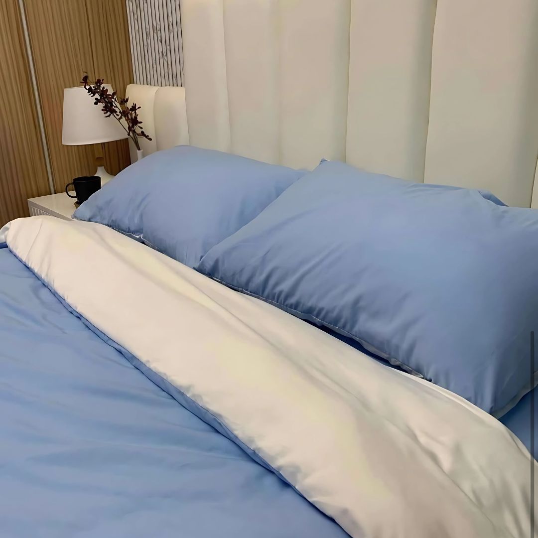 A stylish blue dual-tone reversible duvet cover crafted from 100% cotton, paired with vibrant Ulap bedding sets and USA-made bedsheets, adding both color and comfort to any modern bedroom.