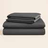 Make your bed the centerpiece of calm. This 4-piece charcoal grey sheet set blends sleek design with breathable comfort.