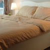 Minimalist bedroom with striped brown duvet and matching pillows