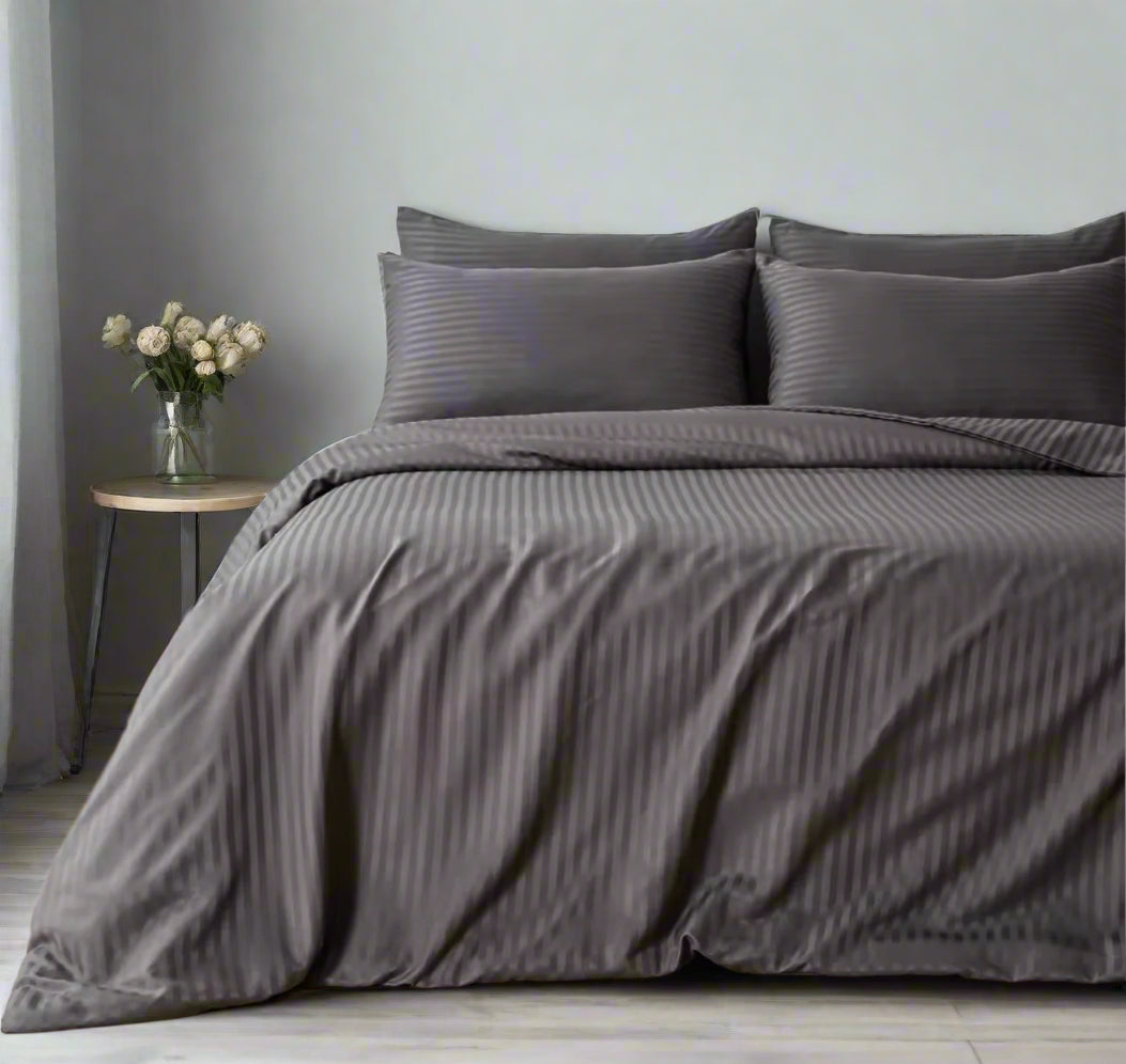Cotton grey striped duvet cover draped over a modern bed