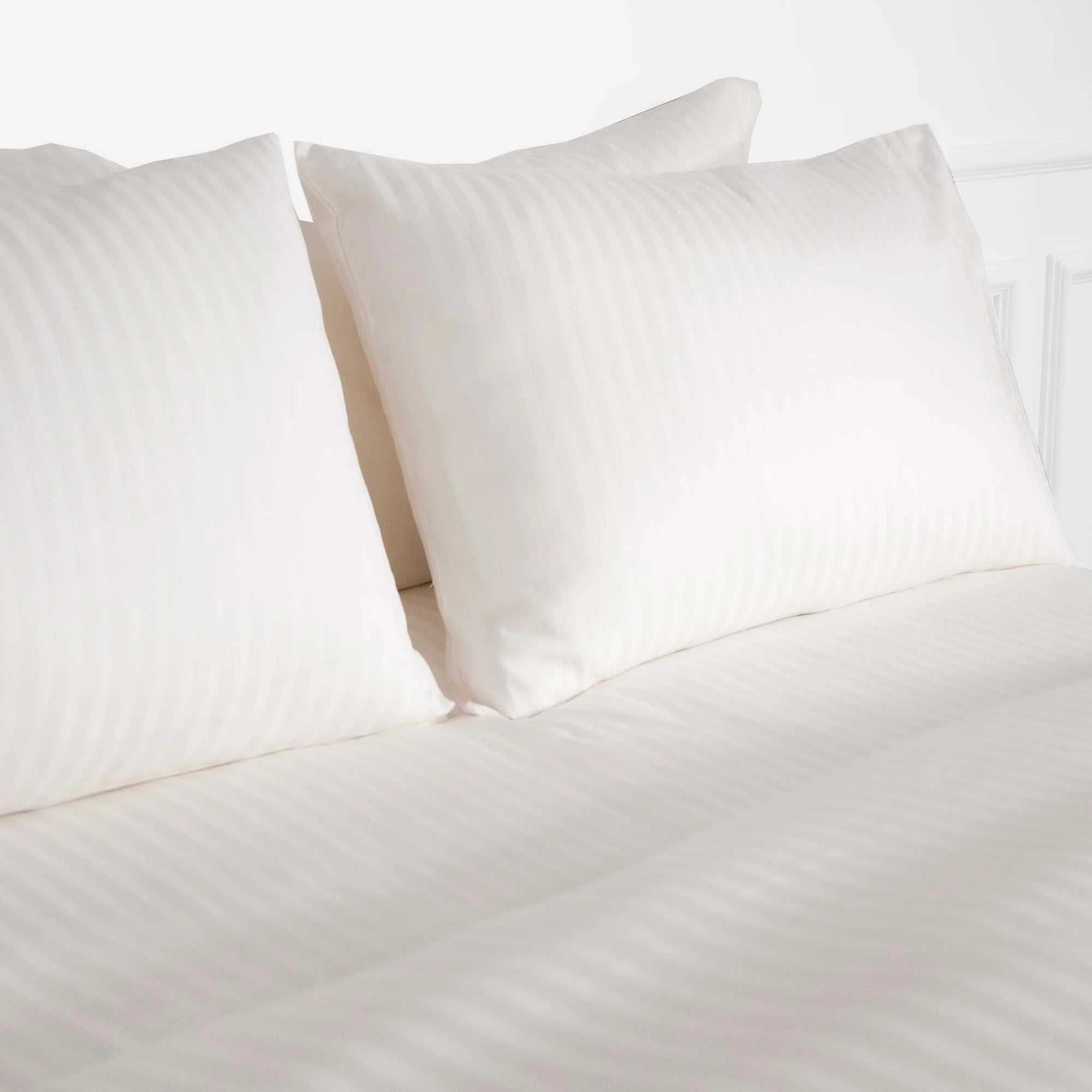 Pearl-striped cotton bedding set with a soft and breathable finish, blending elegance and comfort for a sophisticated bedroom style.