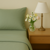 A sage green minimalist duvet cover from a colorful bedding set, featuring USA-made sheets that bring a modern, serene look to any bedroom.